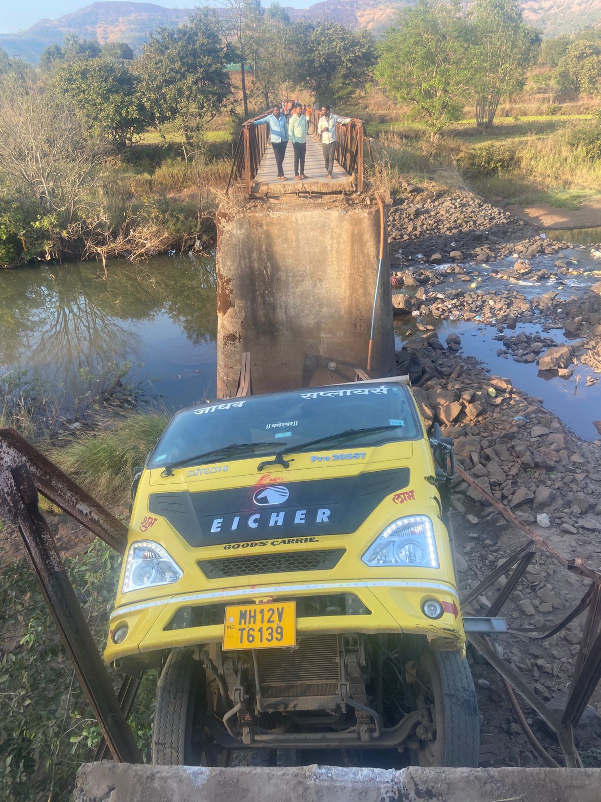 A heavy sand-laden tempo sits amidst the ruins of the Rajgad bridge. Years of administrative apathy and the recent passage of a heavy vehicle led to the total collapse of this vital 40-year-old link, cutting off several villages.